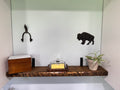 Dark walnut floating shelf mounted above kitchen sink with decor