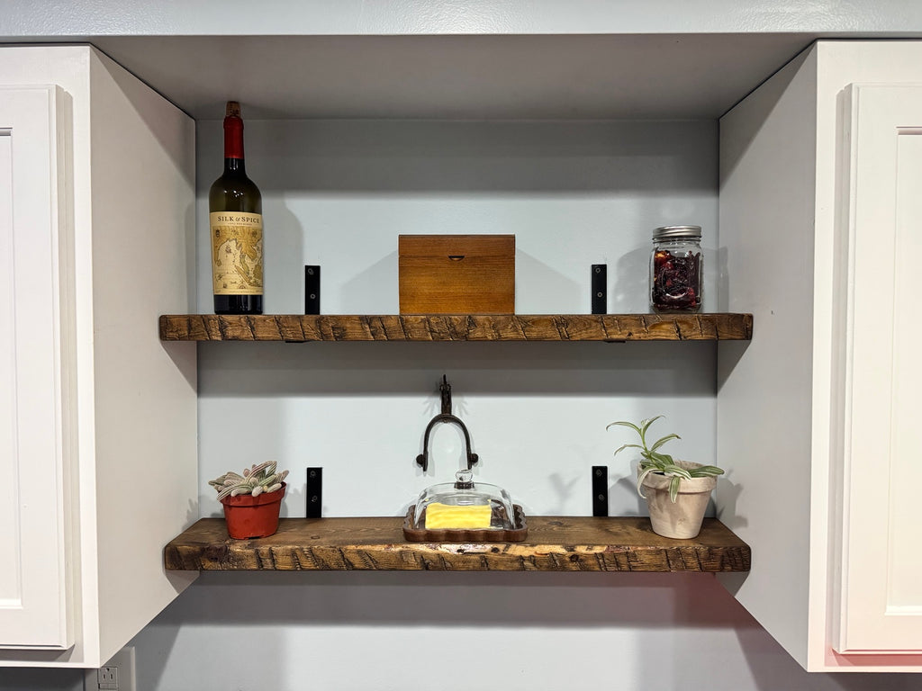 Two dark walnut floating shelves styled in kitchen nook