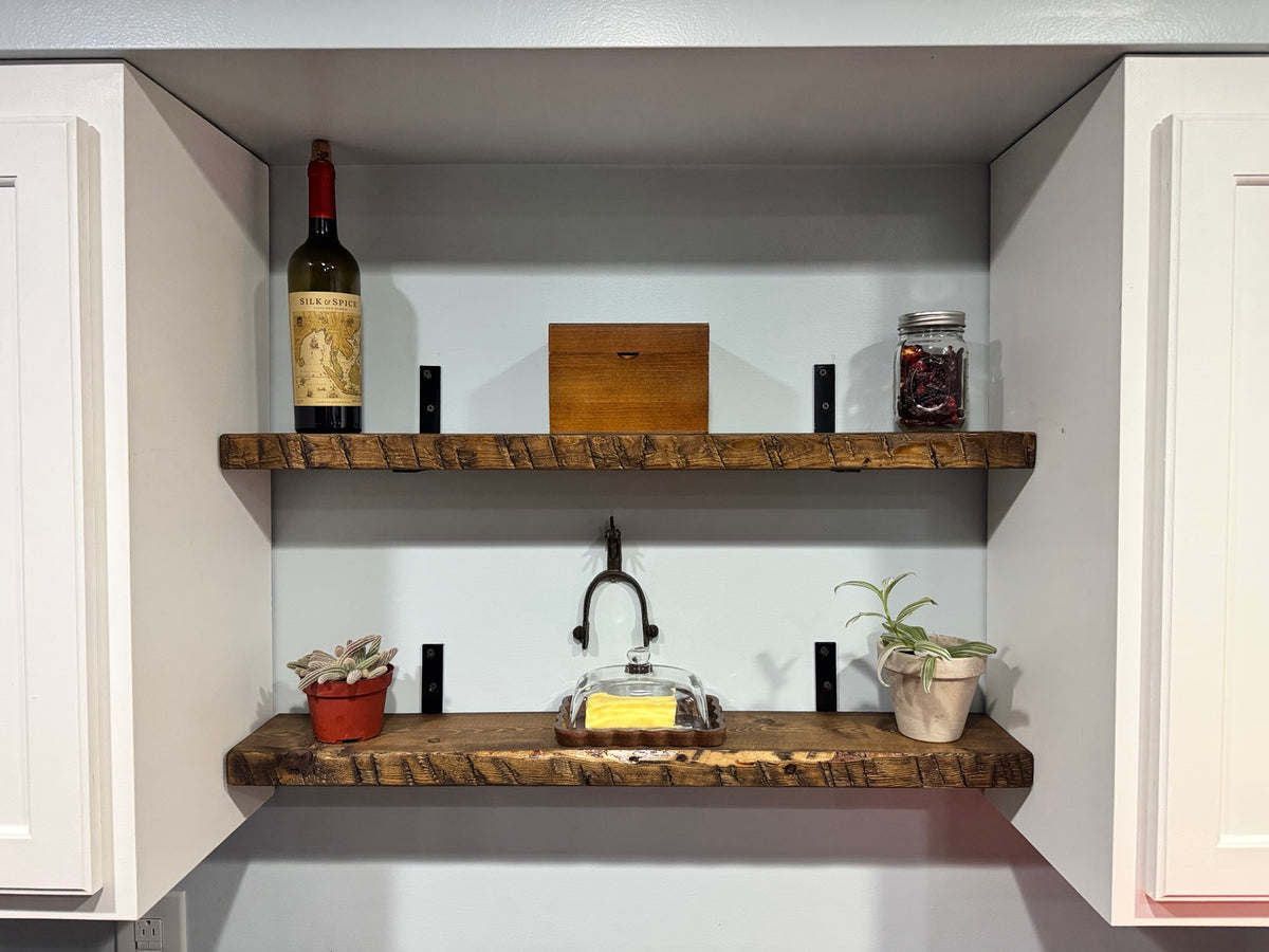 Two dark walnut floating shelves styled in kitchen nook